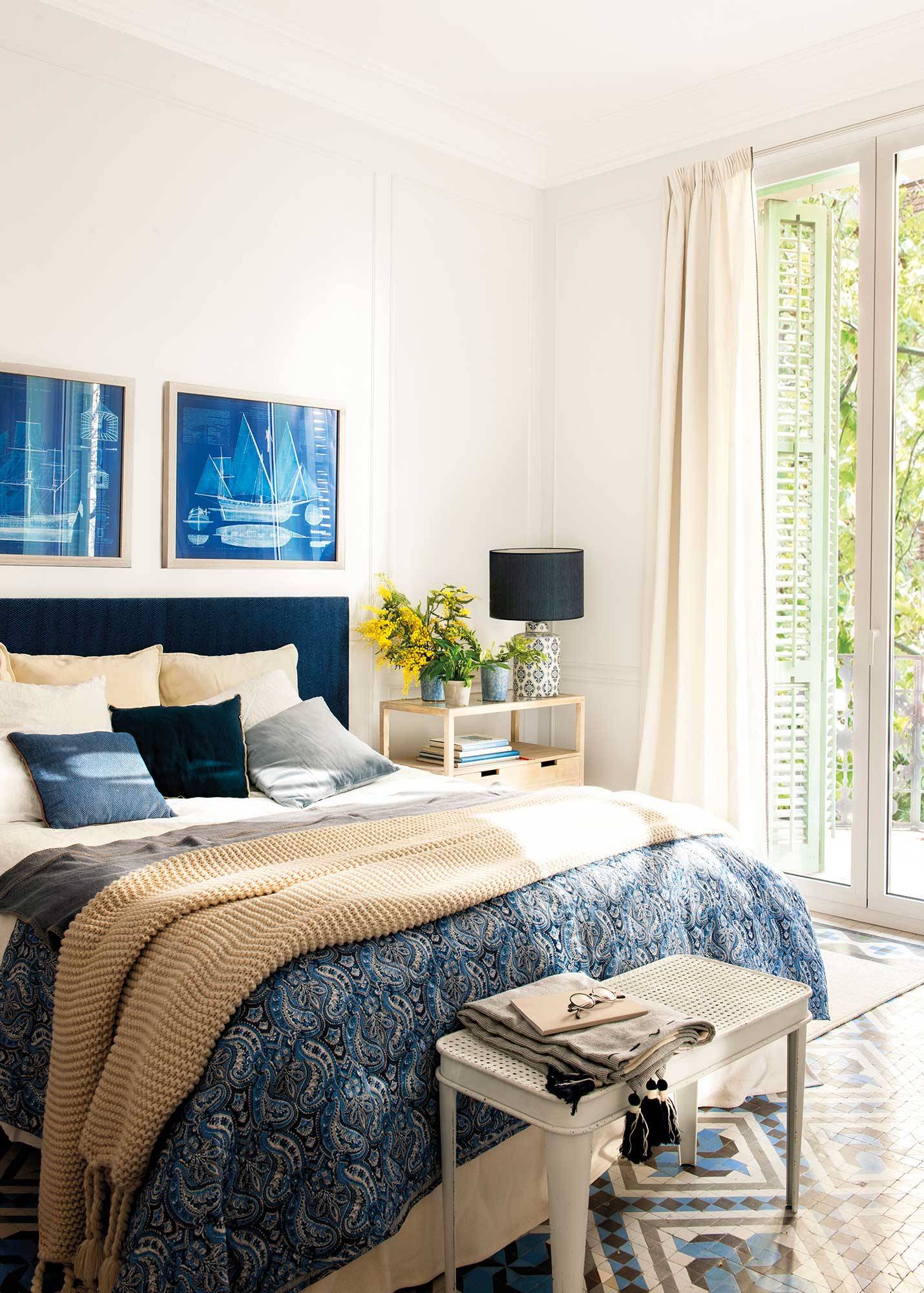 Bedroom with headboard, bedding and blue paintings 00521166
