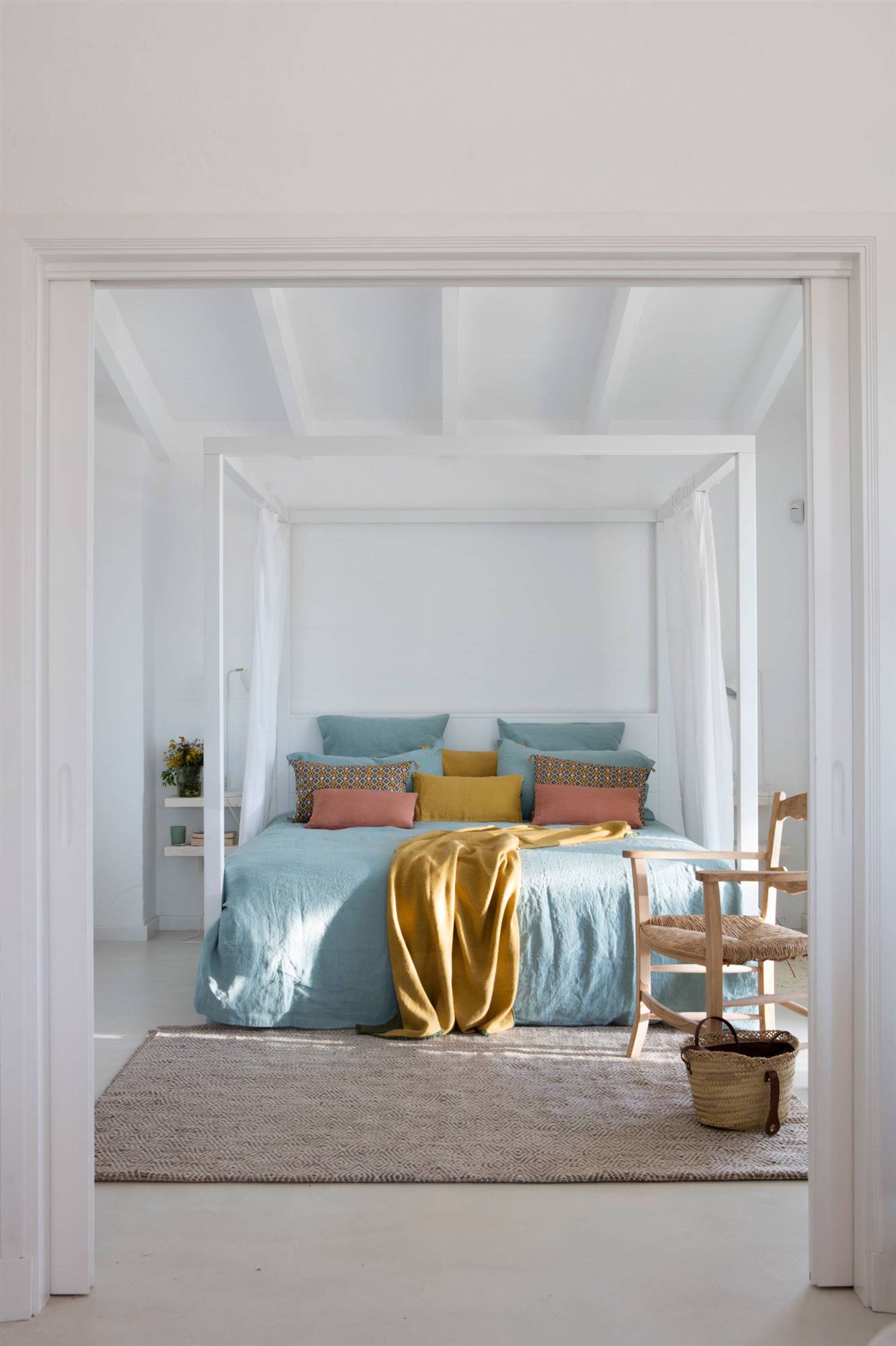 White summer bedroom with canopy bed
