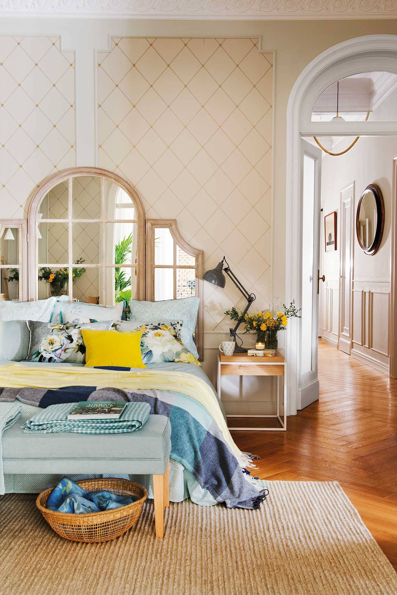 Classic bedroom with mirrored headboard and yellow Illuminating cushion