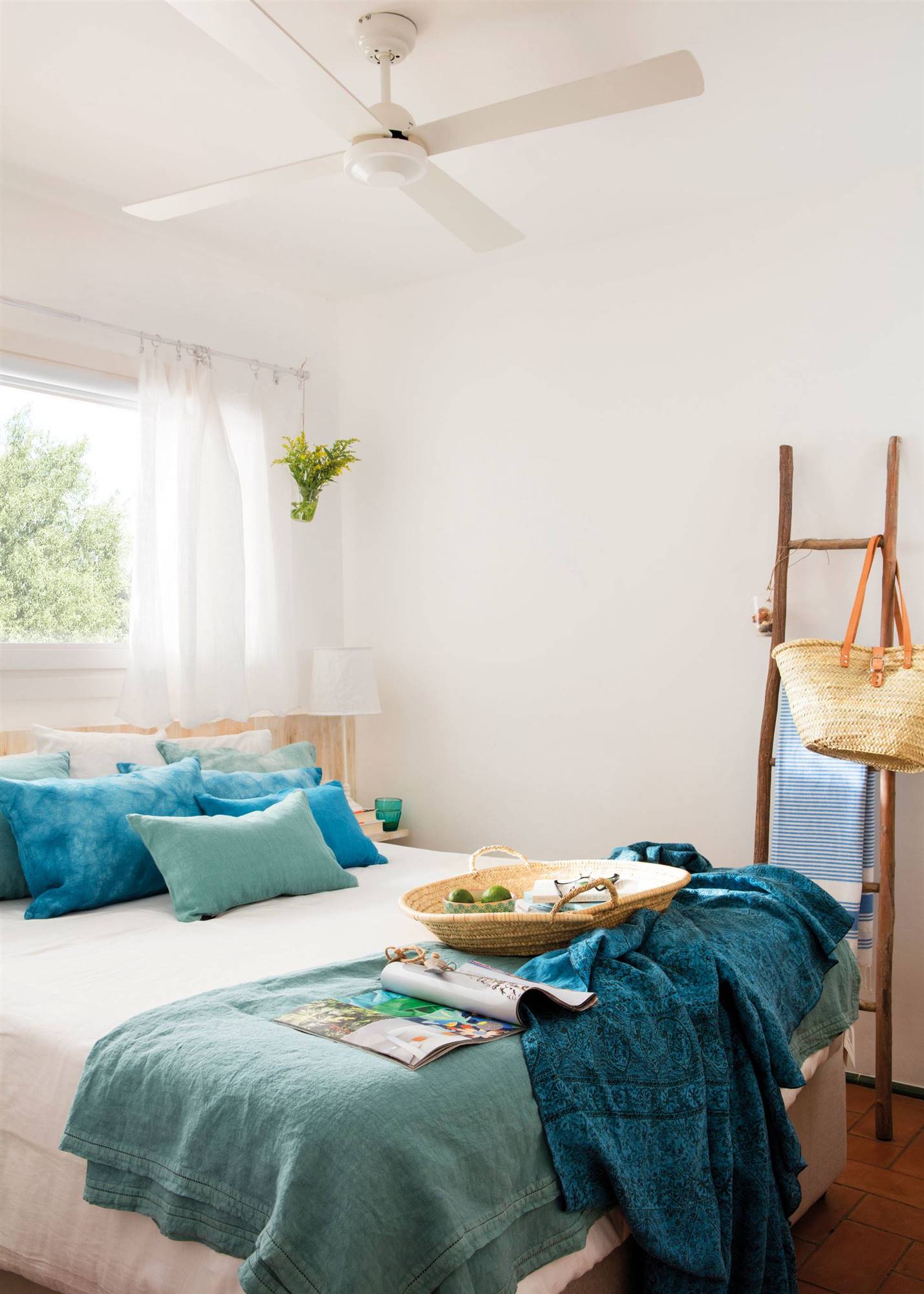 Summer bedroom with blue bedding