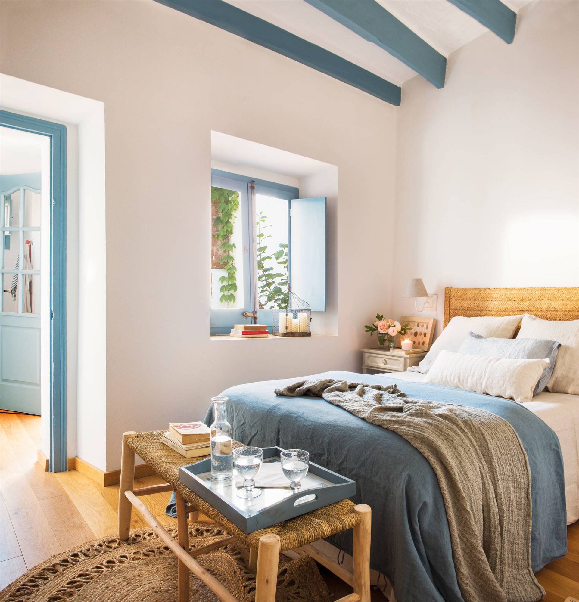 Summer bedroom with white walls and blue beams